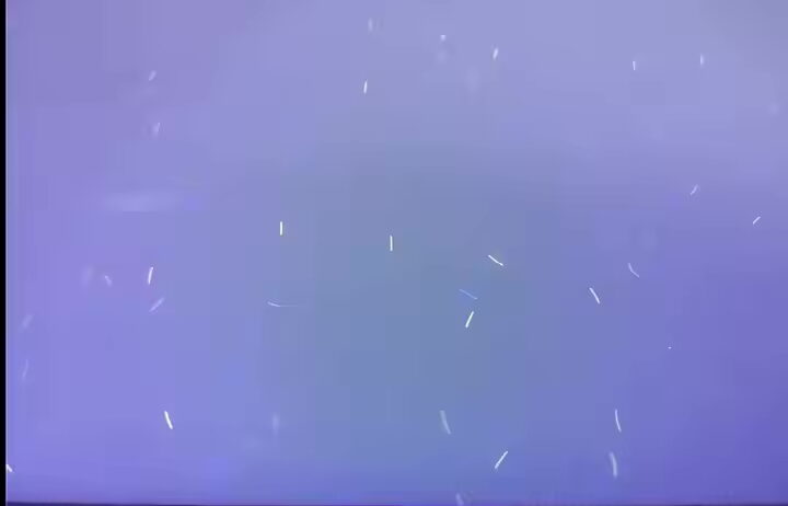 Paper with embedded UV-indicating flakes