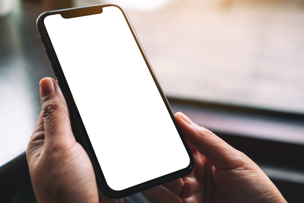Mockup image of woman's hands holding black mobile phone with blank desktop screen